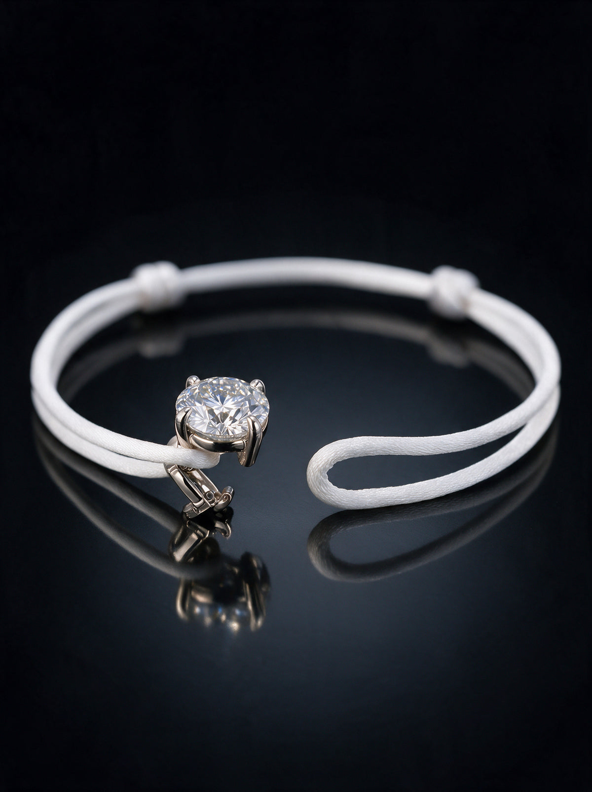 The Alwan Bracelet shown open, with its detachable clasp under the diamond