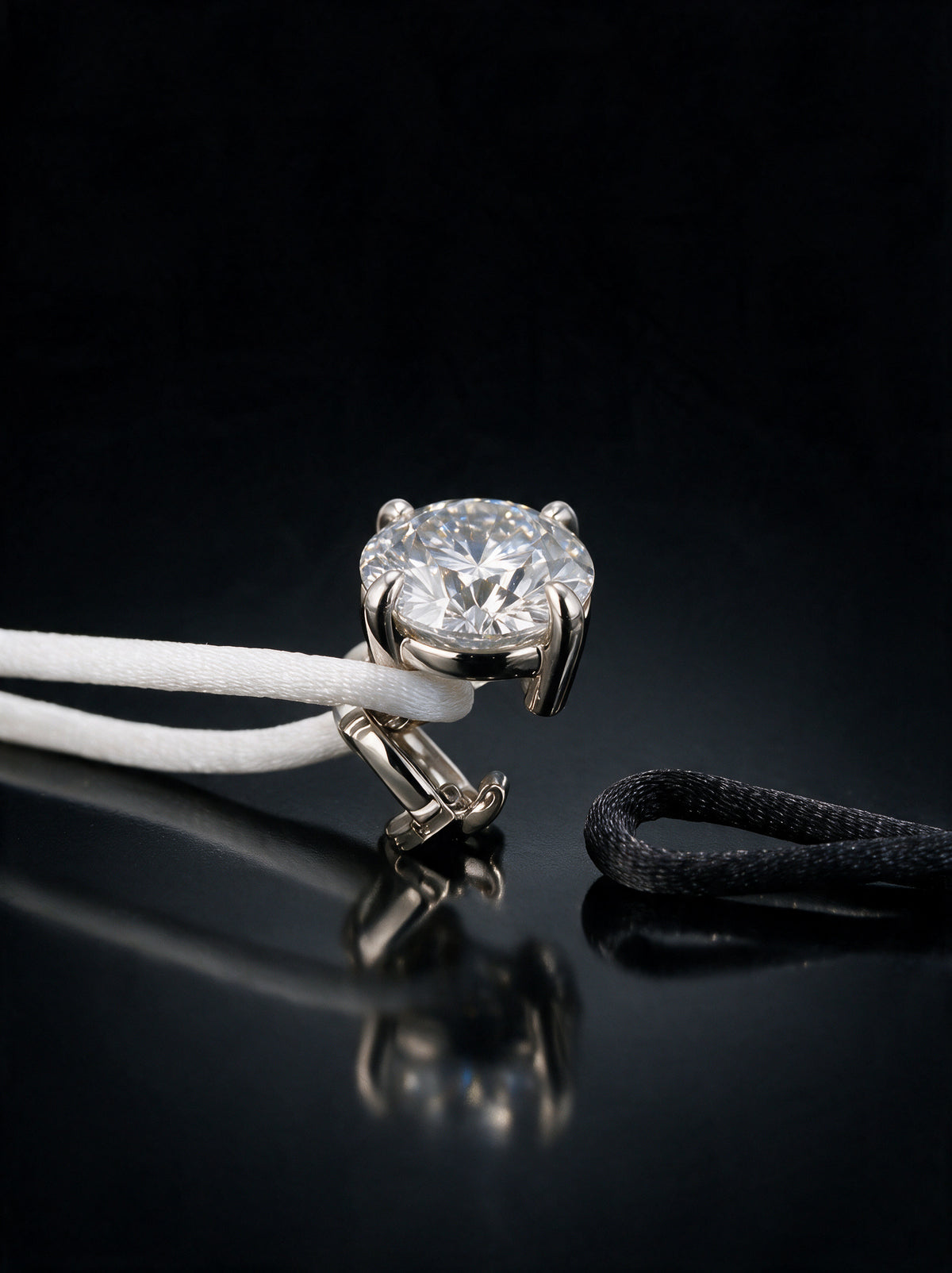 The Alwan Bracelet with its clasp open and a second satin cord ready to clip in